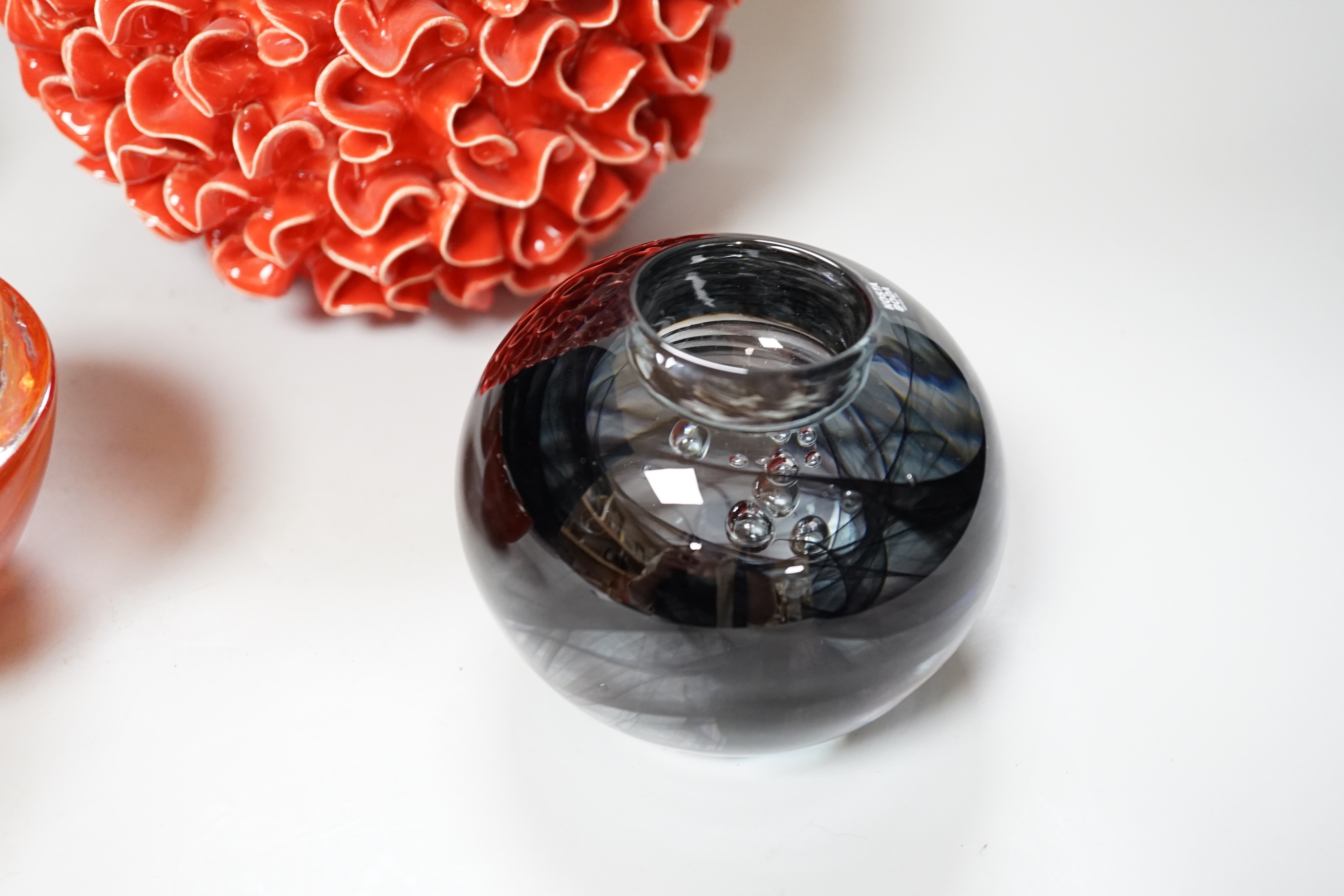An orange pottery organic design vase, a pair of orange Kosta Boda glass candle holders and a grey glass holder, the largest 22cm high